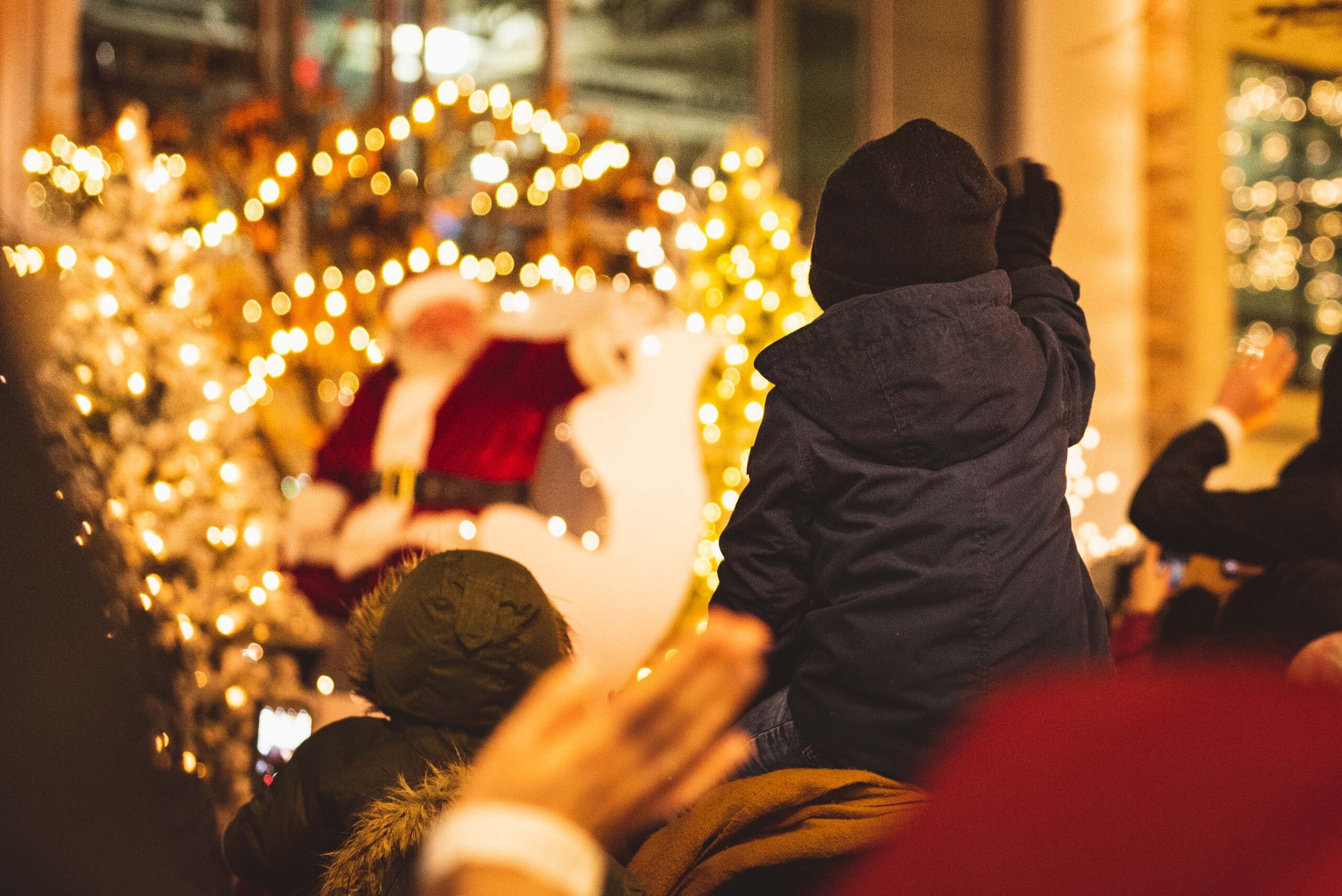Child waving to Santa